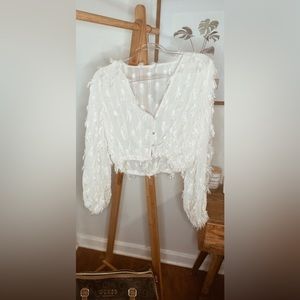 Shear cream/white blouse, feather sparkle addition, buttons are adjustable.